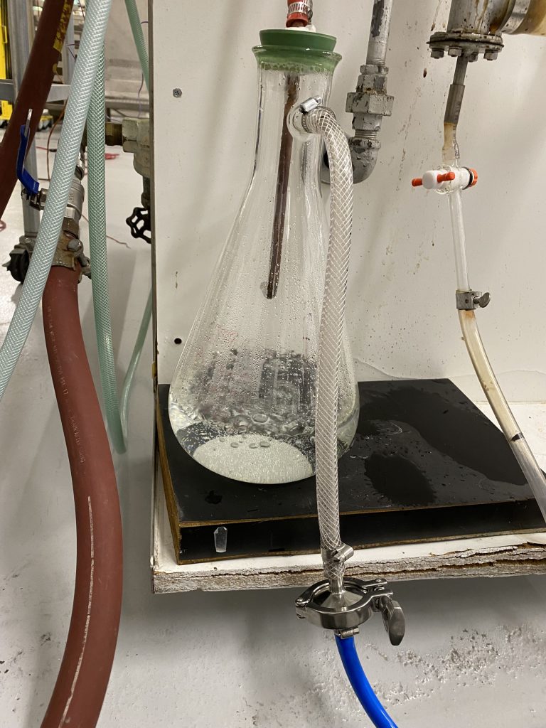 Water boils in a Buchner flask (under vacuum) after the steam input was removed.