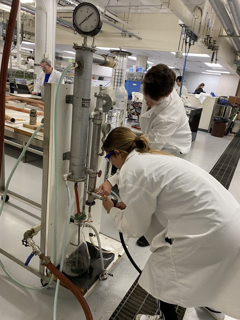 Emily and Ryan connecting the steam trap to the bottom of the steam jacket.