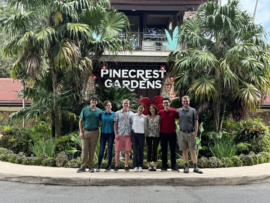 The Parrotronix team poses for a photo in front of the Pinecrest Gardens main entrance.