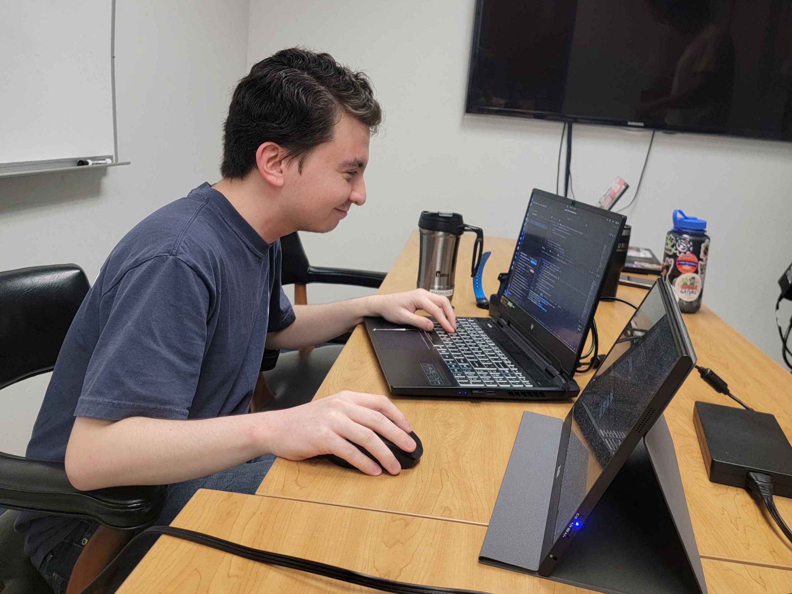 Brian working at a table with a laptop.